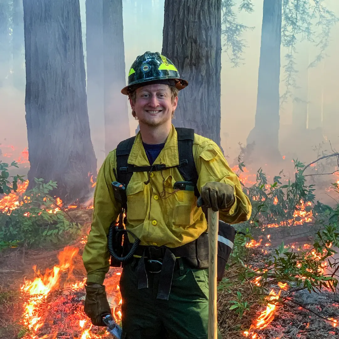 Ryan poses during prescribed burn operations at the Grove of Old Trees, a privately-owned, old growth redwood stand near Occidental, CA in Fall 2023.