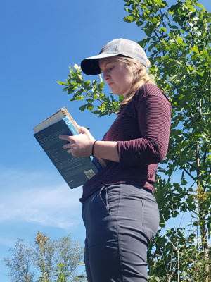 Caption: Alli learning to qualitatively describe and sketch the prairie at Governor Nelson State Park. Photo credit: Mark Parrish