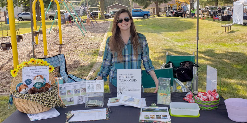 Swann manning a booth for the SWLC at a community event. Photo courtesy of Aran Swann