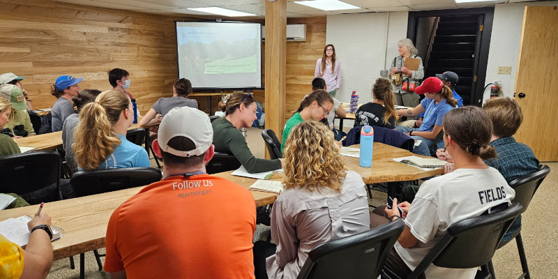 Swann presenting in front of a group. Photo courtesy of Aryn Swann