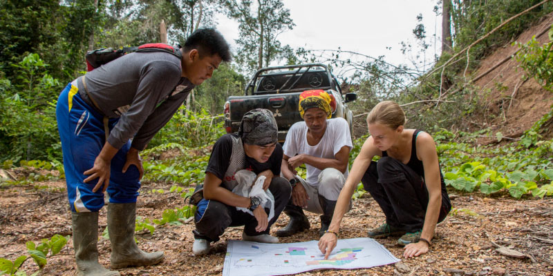Buřivalová (right) conducting field work in Borneo reviews forestry management plan maps with collaborators from The Nature Conservancy Indonesia. Photo credit: Justine Hausheer, The Nature Conservancy