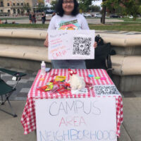 Le tabling for the Campus Area Neighborhood Association at the Library Mall on campus.