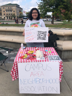 Le tabling for the Campus Area Neighborhood Association at the Library Mall on campus.