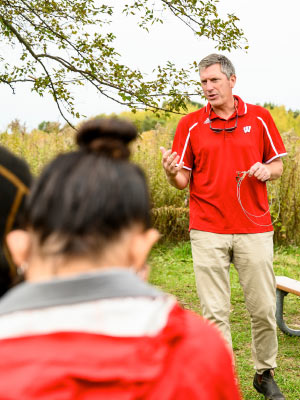 Drake shows Family Weekend participants the equipment his team uses to safely trap canids.