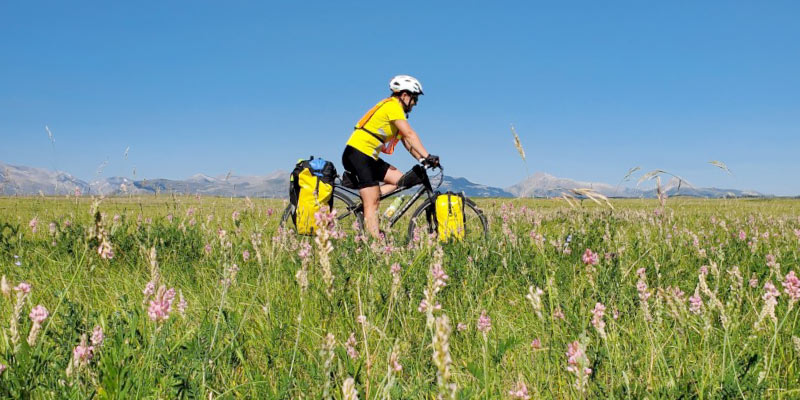 French biking through a field in Montana with the Wild Rockies Field Institute. Photo courtesy of Rachel French