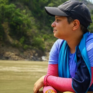 Fleury in the field overlooking a river. Photo by Nitesh Singh