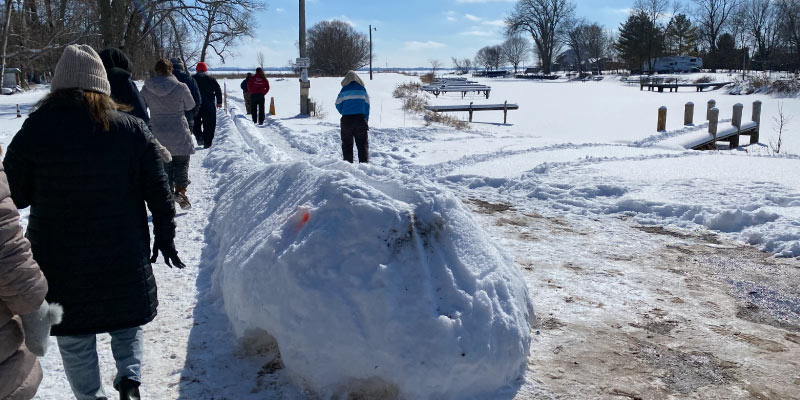 Photos from an Intertribal gathering at the Wisconsin InterTribal Lake Winnebago Connectivity Project for Wild Rice conservation site. This event, attended by Kuhn's capstone class, promoted community and awareness of traditional snow activities including the game Snow Snake. Photos by Hailey Kuhn