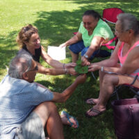 Ho-Chunk elders Woody White, wanagira, Ho-Chunk for “has walked on,” Marie Lewis, and Dawn Decorah are pictured here with Conaway doing a botany activity with wamaxe, wild ginger, and Asarum canadense. Photo credit: Michelle Cloud