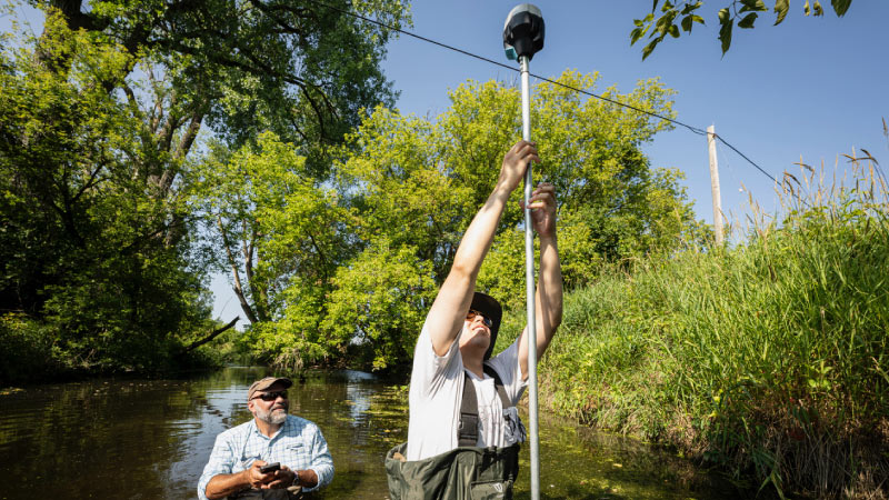 WRM student German Gonzalez and instructor Ed Boswell conducting field work on Koshkonong Creek in Summer 2023. Photo by Bryce Richter / UW–Madison