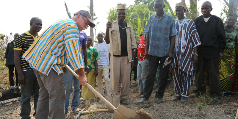 Mitman breaks ground for a new school in Gomue, Liberia, Emmanuel Urey’s village, where a counter-plantation model of development is underway. Photo by Emmanuel Urey.