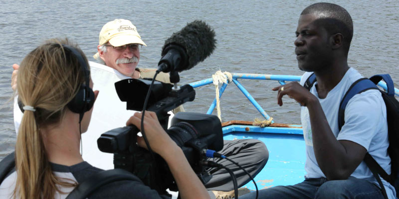 Mitman and Siegel filming Urey on the Du River, an important transportation corridor for Firestone in the early years of its operations in Liberia. Photo by James Weegi.