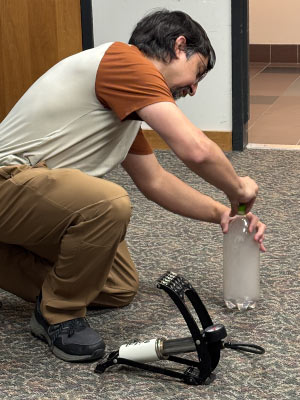 Michael Notaro demonstrates the “cloud in a bottle” experiment. Photo by Erin Berry