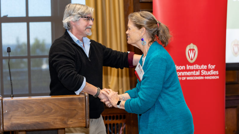 Dean Paul Robbins congratulates Arlyne Johnson, a 2024 Distinguished Alumni Award winner.