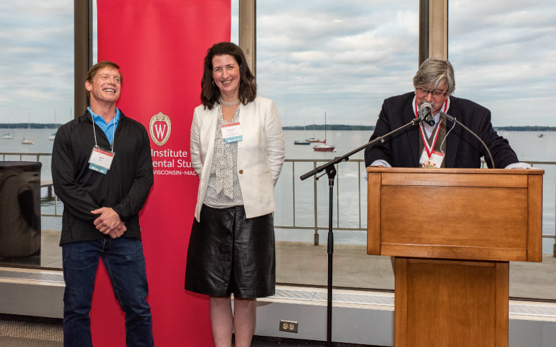 Jeff Rudd (left) helps Tracey Holloway (center) celebrate her honorary professorship: the inaugural Jeff Rudd and Jeanne Bissell Professor of Energy Analysis and Policy professorship. Photo credit: Ingrid Laas