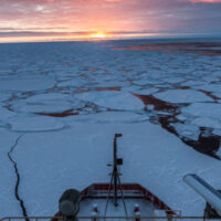 The U.S. icebreaker R/V Nathaniel B. Palmer travels through sea ice in the Southern Ocean as the sun rises for the first time at the end of the polar night. Photo credit: Ben Adkison