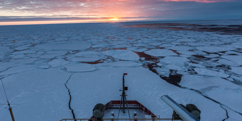 The U.S. icebreaker R/V Nathaniel B. Palmer travels through sea ice in the Southern Ocean as the sun rises for the first time at the end of the polar night. Photo credit: Ben Adkison