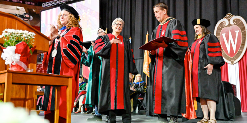 Conservation leader Tia Nelson (center left) received an honorary doctorate degree and, in her speech to the more than 5,000 attendees, reflected on the value of persistence. Photo by Althea Dotzour, UW–Madison