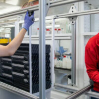 Seunghypeon Jung, a biological systems engineering graduate student, left, and Evan Schmid, a first-year biological systems engineering undergraduate student, work on a direct air capture (DAC) unit. Photo credit: Michael P. King