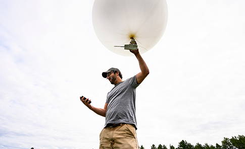 A researcher about to release a weather balloon