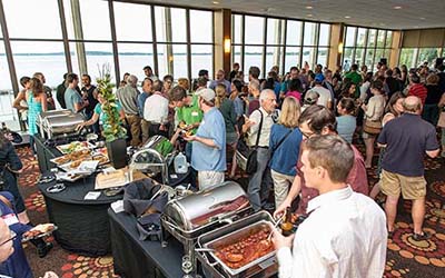 Alumni mingling during a reception at Rendezvous on the Terrace
