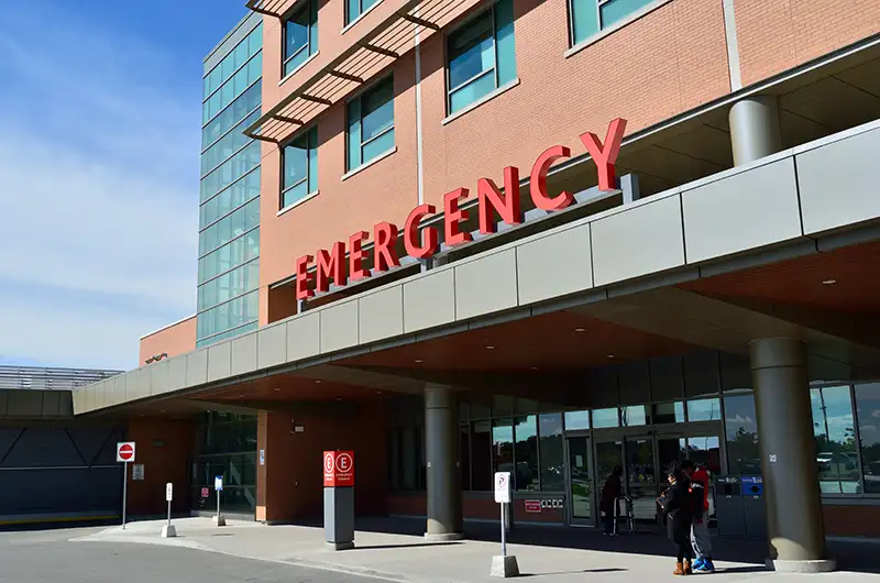 Exterior view of an emergency room entrance at a hospital.