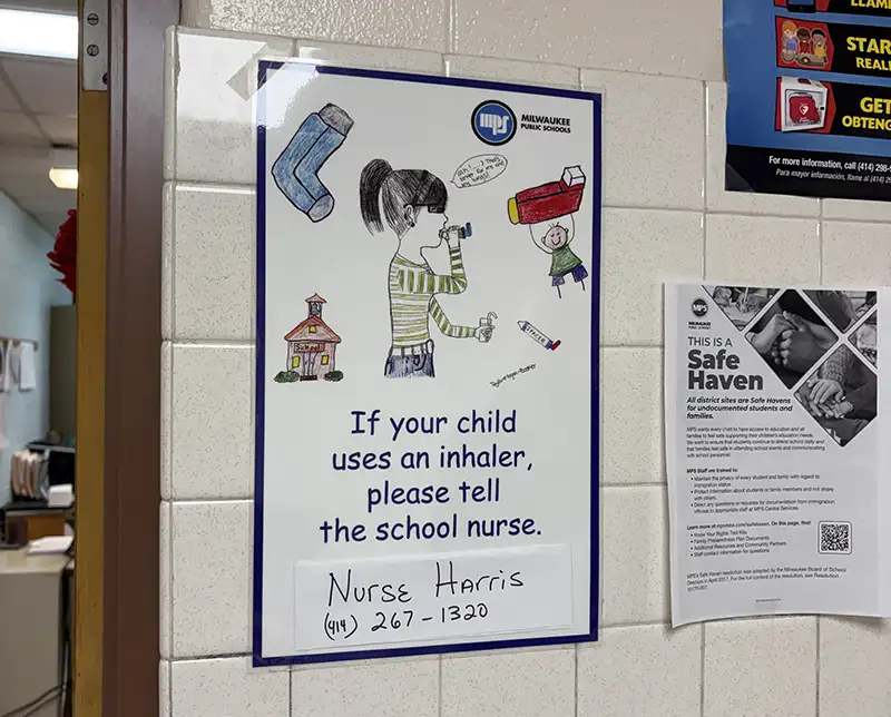 Sign in a school room with instructions to contact the school nurse if a child uses an inhaler.