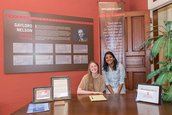 Two students sitting at Gaylord Nelson's desk in Science Hall