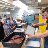 Heather Wolfe (left) and Joshua Calhoun (right) lead a paper making demonstration at SUNY Potsdam.