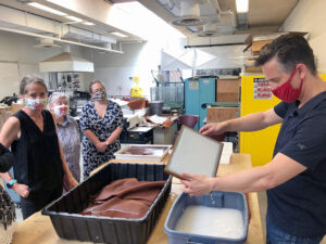 Heather Wolfe (left) and Joshua Calhoun (right) lead a paper making demonstration at SUNY Potsdam.