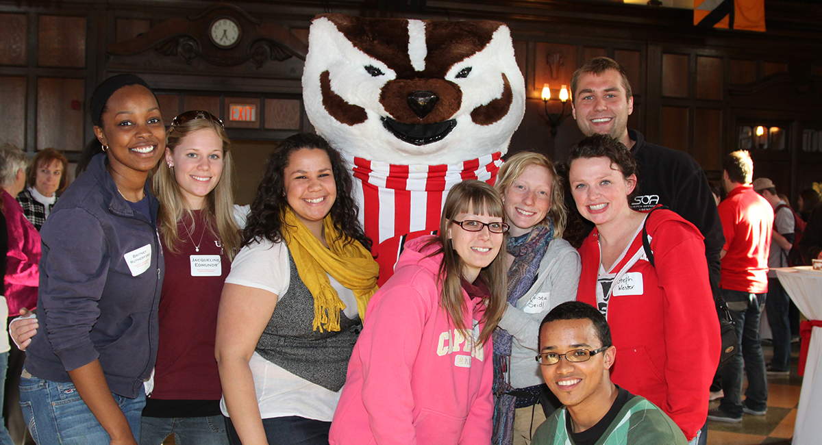 Diverse group of students posing with Bucky Badger.