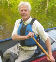Portrait of Tim Palmer paddling a canoe